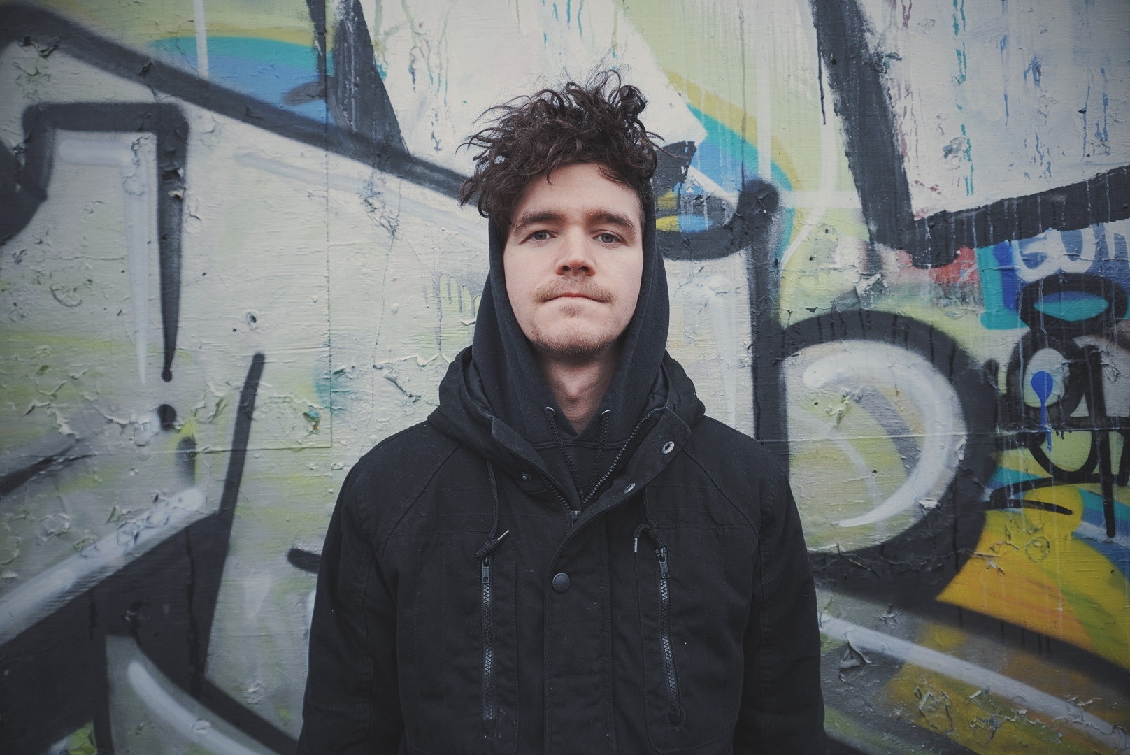 photo of casey tyson-pearce against a graffiti wall