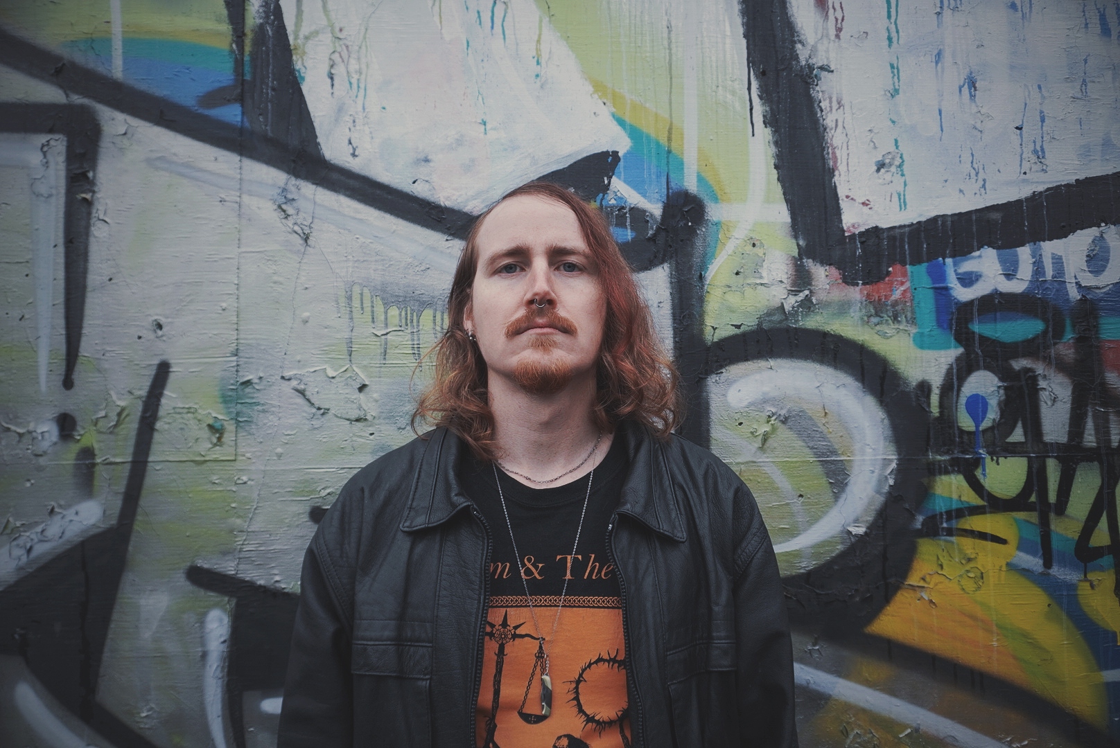 photo of colton bennett against a graffiti wall