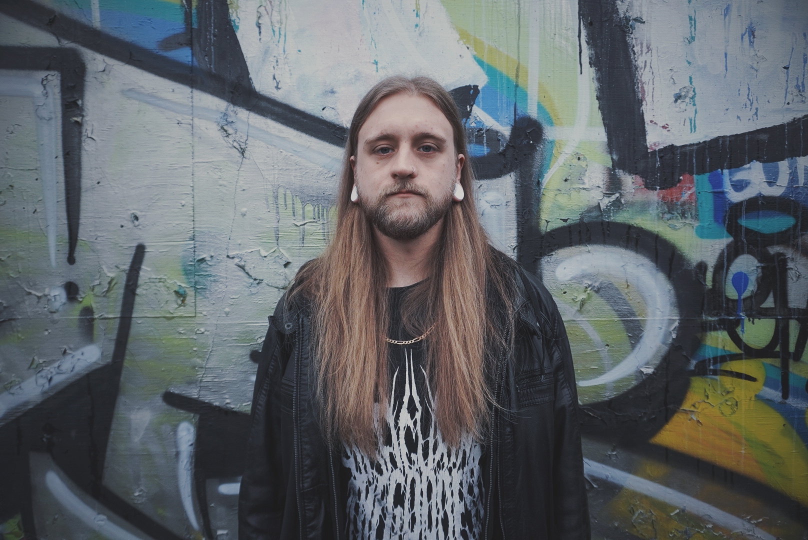 photo of mike greenwood against a graffiti wall